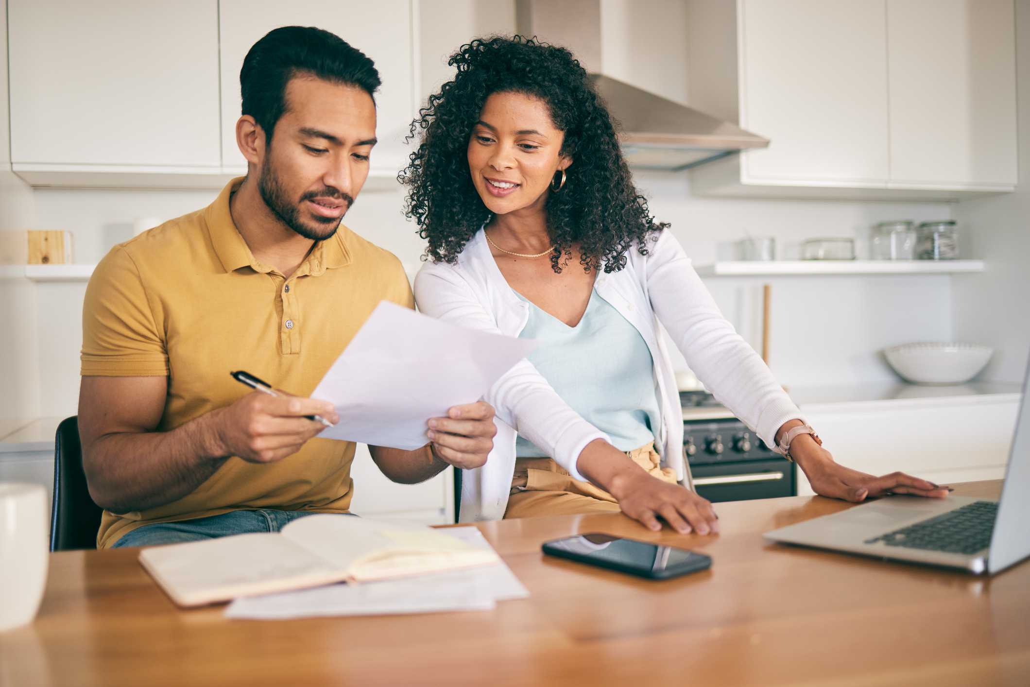 Couple budgeting together at a laptop